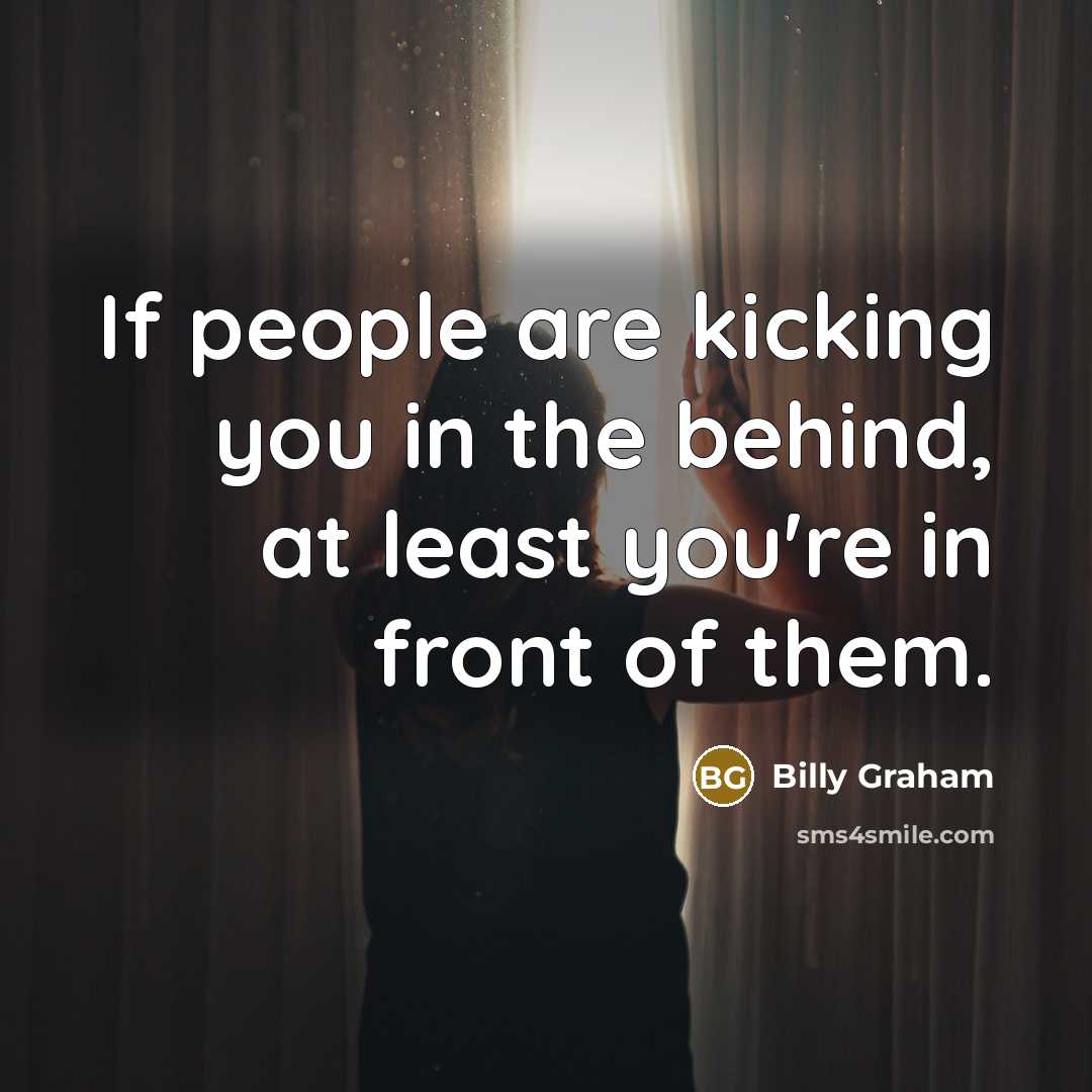 “If people are kicking you in the behind, at least…” quote by Billy Graham