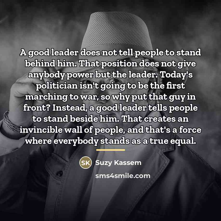 “A good leader does not tell people to stand behind…” quote by Suzy Kassem
