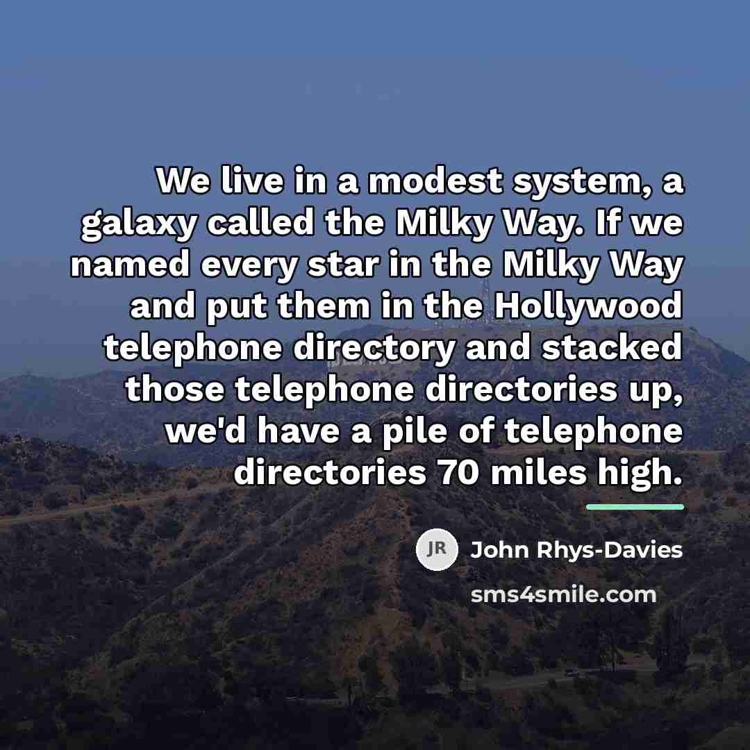 “We live in a modest system, a galaxy called the…” quote by John Rhys-Davies